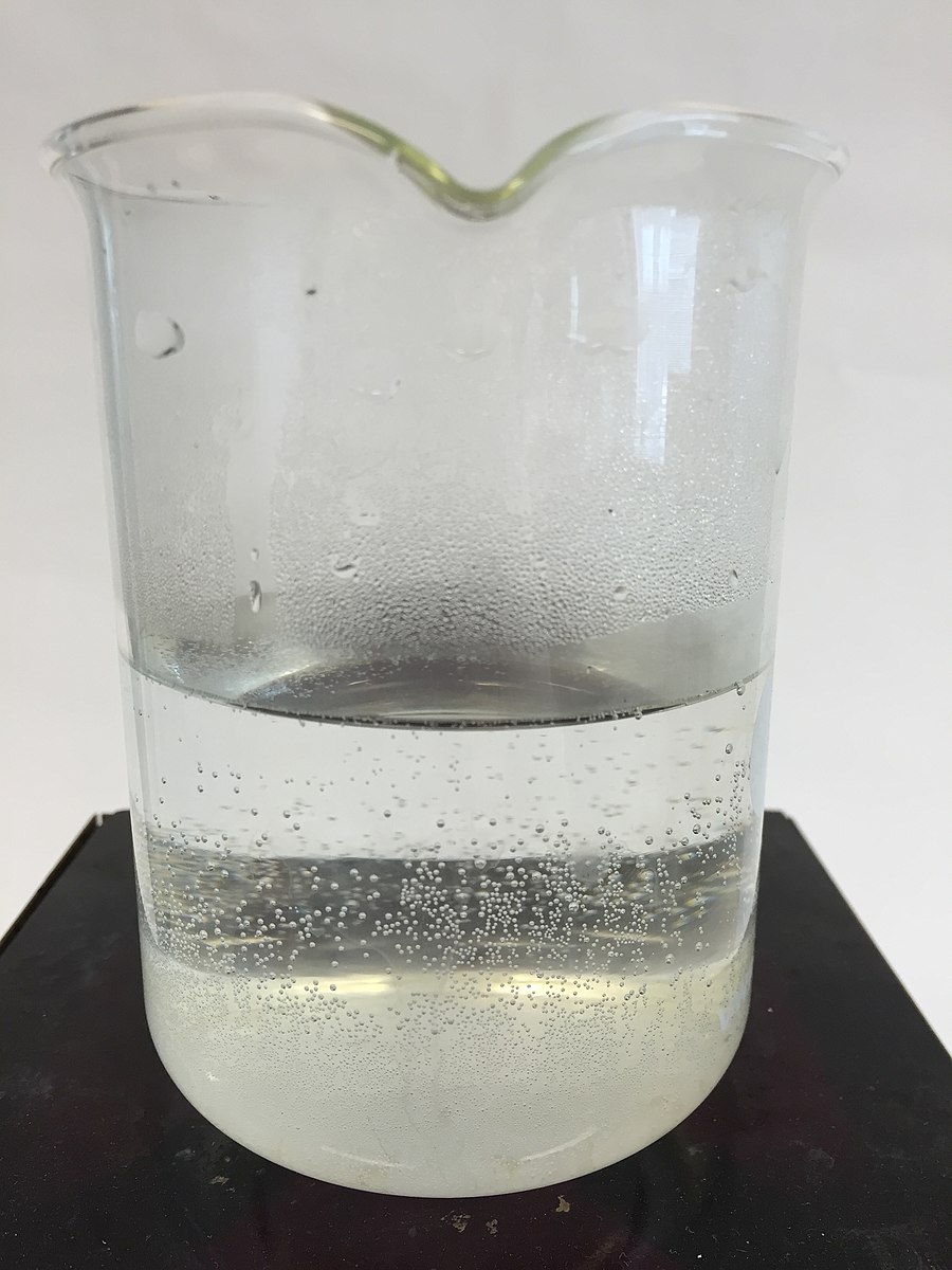 Photo of a beaker with boiling water at the bottom and condensation on the sides